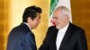 Japanese Prime Minister Shinzo Abe greets Iranian Foreign Minister Mohammad Javad Zarif at the start of their bilateral meeting in Yokohama, August 28, 2019