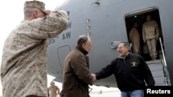 U.S. Defense Secretary Leon Panetta (right) is greeted by U.S. Ambassador to Afghanistan James Cunningham upon Panetta's arrival at Kabul International Airport on December 12.