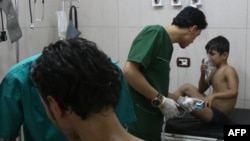 Doctors treat Syrians suffering from breathing difficulties at a makeshift hospital in Aleppo on September 6.