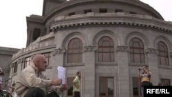 An opposition activist holds a protest in Yerevan's Liberty Square in June.