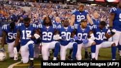 Some members of the Indianapolis Colts kneel for the national anthem prior to the start of a game against the Cleveland Browns in Indianapolis, Indiana, on September 24.