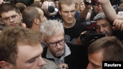 Opposition leader Eduard Limonov (in glasses) attends a protest rally to defend Article 31 of the Russian Constitution, which guarantees the right of assembly, in Moscow on July 31.