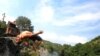 Children jump to cool off in the River Treska, a hundred meters below the Matka Dam, west of Skopje on August 15. Temperatures in Macedonia reached 39 degrees Celsius. <br /><br />Photo by Robert Atanovski for AFP