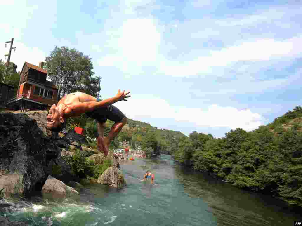 Children jump to cool off in the River Treska, a hundred meters below the Matka Dam, west of Skopje on August 15. Temperatures in Macedonia reached 39 degrees Celsius. Photo by Robert Atanovski for AFP