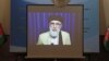 A screen shows the broadcast of Gulbuddin Hekmatyar during a signing ceremony with Afghan government at the presidential palace in Kabul on September 29.