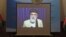 A screen shows the broadcast of Gulbuddin Hekmatyar during a signing ceremony with Afghan government at the presidential palace in Kabul on September 29.