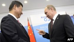 Russian President Vladimir Putin (right) chats with his Chinese counterpart Xi Jinping before the G20 summit in St. Petersburg late last year.