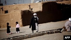 FILE: Afghan refugees in Shahid Nasseri refugee camp in Taraz Nahid village near the city of Saveh, some 130 kilometers southwest of the capital Tehran.