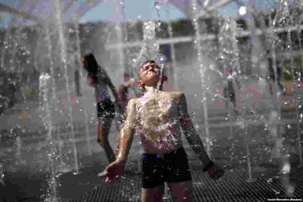 A boy plays in a fountain on a hot day in Volgograd, Russia. (Reuters/Ueslei Marcelino)