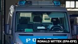 A police car arrives at a police station in Karlsruhe, Germany, on April 15. German federal police arrested five Tajik nationals, suspected members of an Islamic State terrorist cell.