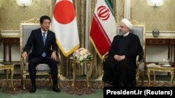 Iranian President Hassan Rohani (right) meets with Japanese Prime Minister Shinzo Abe in Tehran on June 12.