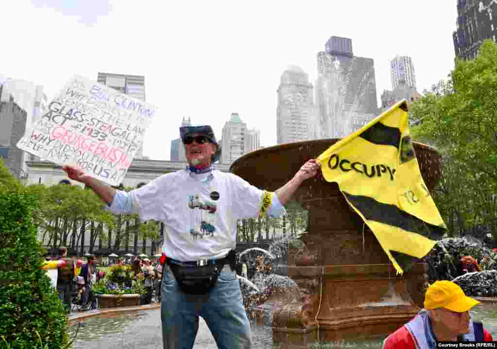 A protester stood on Bryant Park's fountain and shouted that both the Democratic and Republican parties are guilty of corruption and greed.