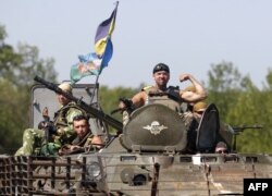 A Ukrainian serviceman poses on an APC in the Donetsk region, where there is still heavy fighting, on August 9.