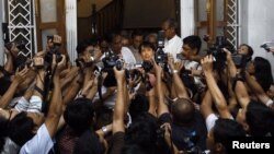 Pro-democracy leader Aung San Suu Kyi speaks to reporters after meeting with UN special envoy to Myanmar Vijay Nambiar in May.