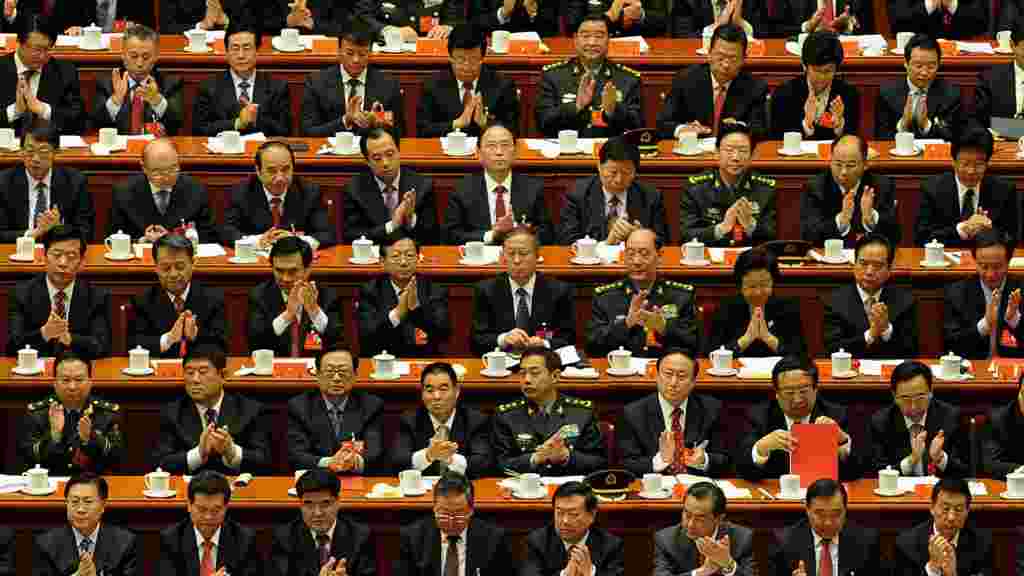 Delegates clap after a speech by outgoing Chinese President Hu Jintao during the closing ceremony of the Party Congress at the Great Hall of the People in Beijing. (AFP/Mark Ralston)