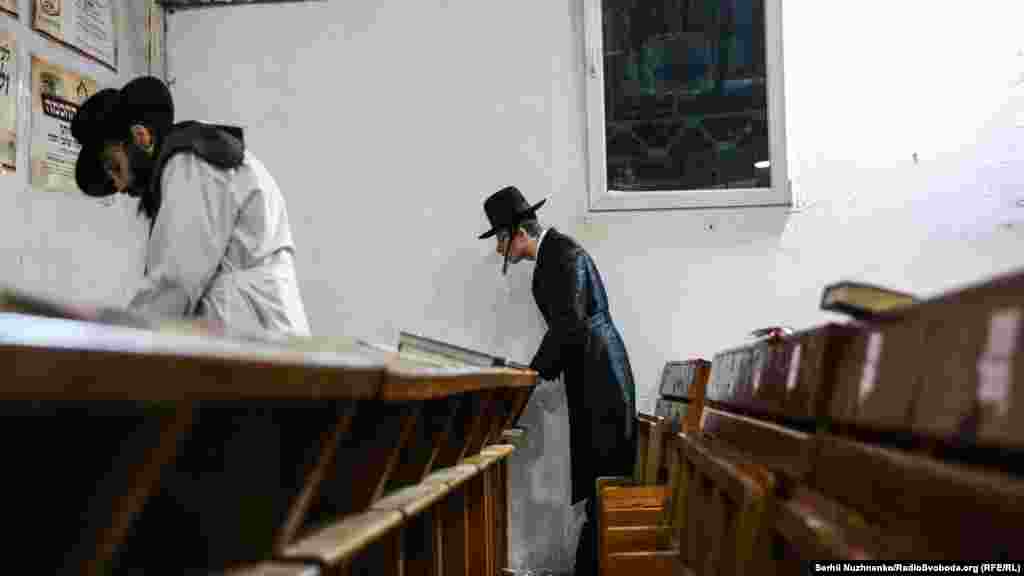 Some faithful pilgrims stay in synagogue after the evening prayers are finished.