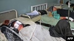 Wounded Afghan women lie in beds in a hospital in Mihtarlam, Laghman Province, on September 16, when NATO was accused of killing eight women who were gathering wood.