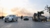 Fighters of the Islamic State of Iraq and the Levant (ISIL) stand guard at a checkpoint in the northern Iraqi city of Mosul on June 11.