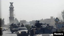 An Afghan military convoy travels along the main road of the city of Kandahar on October 5.