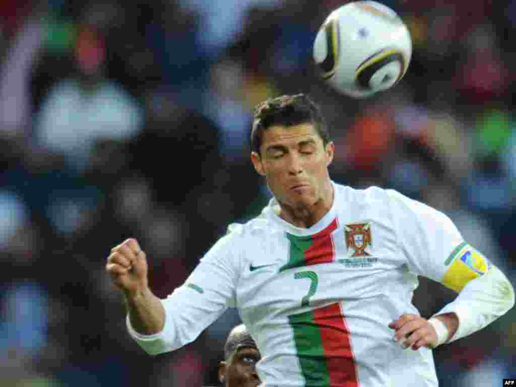 South Africa -- Portugal's striker Cristiano Ronaldo during the Group G first round 2010 World Cup football match Ivory Coast vs. Portugal in Port Elizabeth, 15Jun2010 - SOUTH AFRICA, Port Elizabeth : Portugal's striker Cristiano Ronaldo heads the ball past Ivory Coast's midfielder Didier Zokora during the Group G first round 2010 World Cup football match Ivory Coast vs. Portugal on June 15, 2010 at Nelson Mandela Bay stadium in Port Elizabeth
