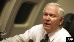 U.S. Secretary of Defense Robert Gates speaks to members of the press aboard his plane en route to Cairo.