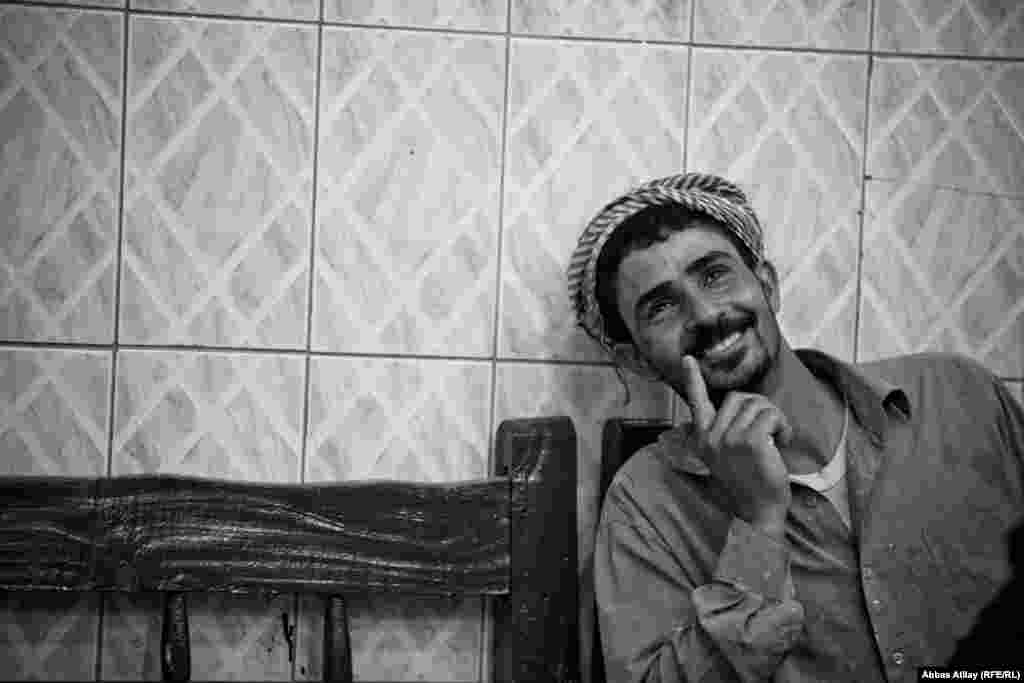 A construction worker in Kirkuk enjoys some free time in a tea house.