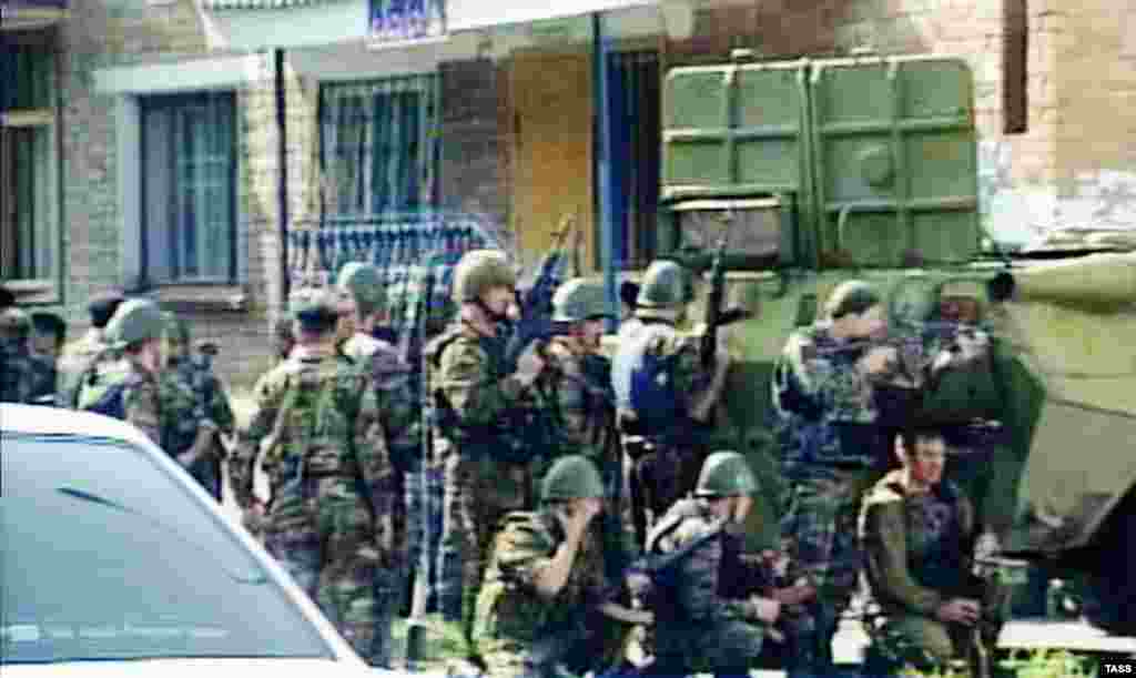 Russian troops gather outside Beslan&#39;s School No. 1.