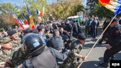 Moldovan police clash with demonstrators during a protest against the government outside the parliament building in Chisinau on October 4.