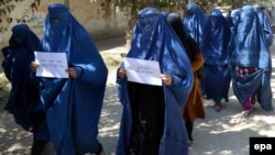 File photo of Afghan women protest against a high-profile gang rape case in 2014.