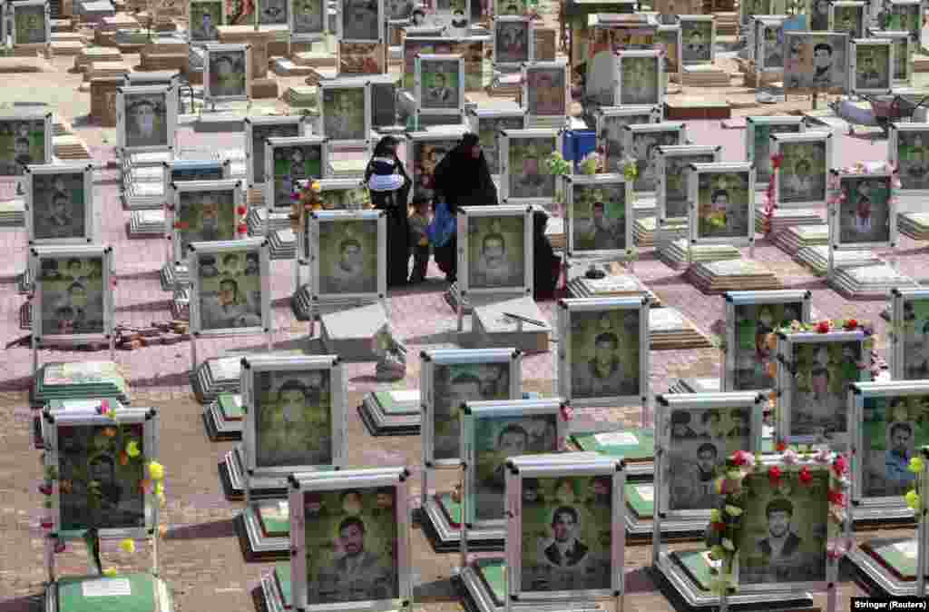 Relatives visit graves in the Mahdi Army cemetery in the holy Iraqi city of Najaf. (Reuters)