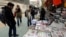 Iranians look at newspapers displayed outside a kiosk on a street of Tehran. (file photo)