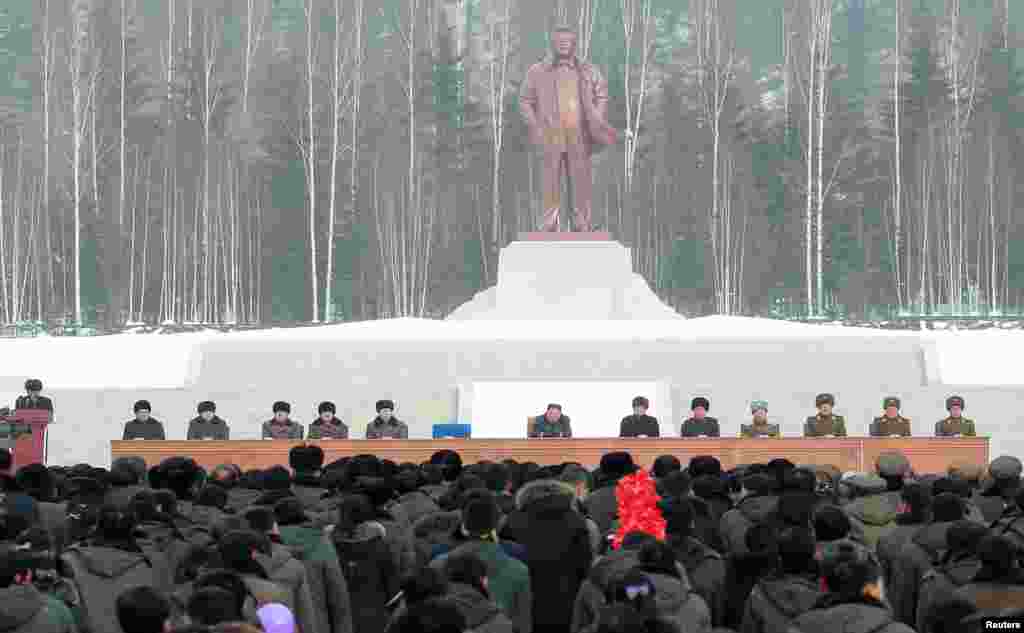 A line-up of communist officials flank Kim during the opening ceremony. The statue is of Kim Jong Il, the second leader of the communist country and Kim Jong Un&rsquo;s late father.