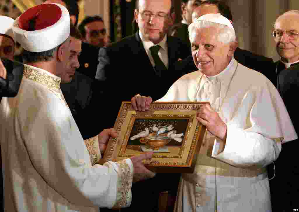 Pope Benedict offers a gift as he visits the Blue Mosque in Istanbul during his historic visit to Turkey in November 2006.