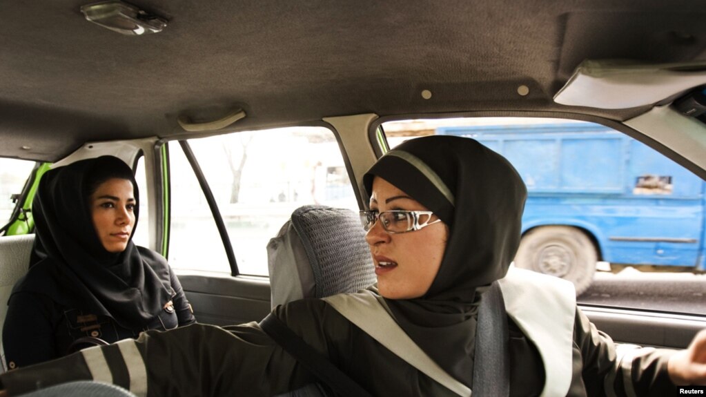 A female taxi driver fetches a passenger in Tehran, 21Aug2011