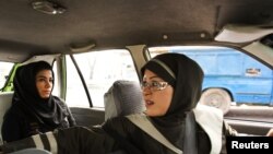 A female taxi driver fetches a passenger in Tehran, 21Aug2011