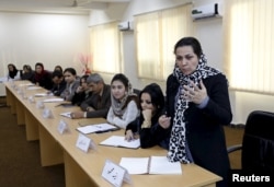 An Afghan woman speaks as they attend a class of the gender and women's studies masters program in Kabul University, October 19.