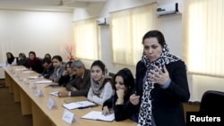 Afghanistan--An Afghan woman speaks during class on October 19, 2015