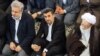 Former president Mahmoud Ahmadinejad (C) and Conservative cleric Mohammad Emami Kashani (R) undated.