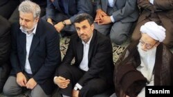 Former president Mahmoud Ahmadinejad (C) and Conservative cleric Mohammad Emami Kashani (R) undated.