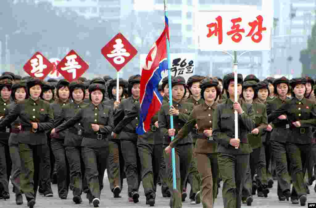 North Korean students sing wartime songs in chorus on Kim Il Sung Square in Pyongyang. (AFP/KCNA)