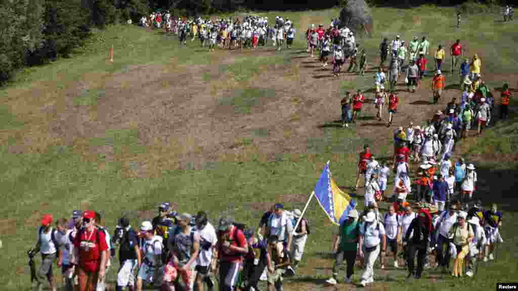 Participants in the 110-kilometer &quot;March of Peace&quot; walk through a forest on July 8 on their way to Srebrenica to retrace in reverse the path taken by Bosnian Muslims fleeing Serb forces in 1995.