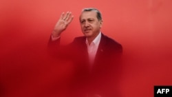 Turkish President Recep Tayyip Erdogan greets supporters during a rally against the failed July 15 military coup in Istanbul on August 7.