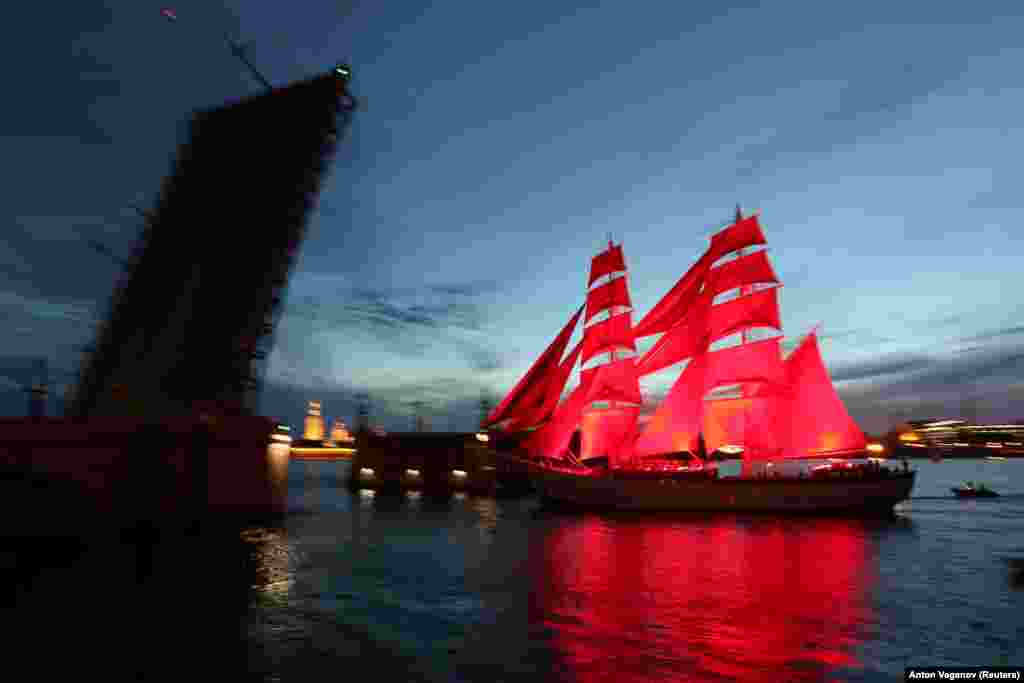 The Rossiya with scarlet sails floats on the Neva River past Troitsky Bridge during a rehearsal for festivities marking school graduation in St. Petersburg, Russia. (Reuters/Anton Vaganov)