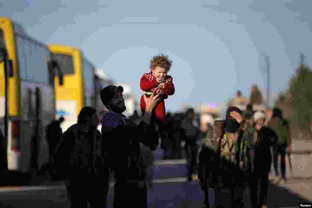 Rebel fighters and their families who had evacuated the besieged Waer district in the central Syrian city of Homs arrive on the southern outskirts of the Syrian city of Al-Bab. (Reuters/Khalil Ashawi)