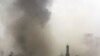 Smoke billows from the scene of one of the explosions in central Baghdad.