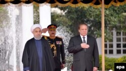 Pakistani Prime Minister Nawaz Sharif (right) with Iranian President Hassan Rohani (left) before their talks in Islamabad on March 25.