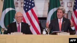 U.S. Secretary of State John Kerry (R) speaks with Pakistani Foreign Affairs Advisor Sartaj Aziz during at the US State Department in Washington, on February 29.