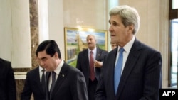 U.S. Secretary of State John Kerry, right, walks with Turkmen President Gurbanguly Berdimuhamedov before their talks at the Oguzkhan Presidential Palace in Ashgabat on November 3.