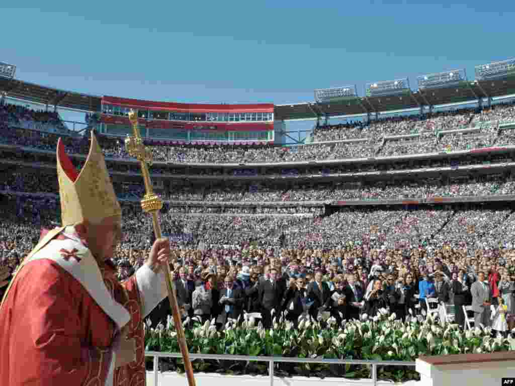 Pope Benedict XVI in Washington D.C. - Pope Benedict XVI stands before the crowd at National Stadium on April 17, 2008 in Washington, DC. The recently finished Nationals' baseball stadium became a "church for a day" when Pope Benedict celebrated the first of two huge open-air masses during his six-day visit to the United States.