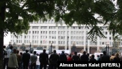 Casino workers protest their workplace closures outside the Kyrgyz parliament building in Bishkek on September 29.